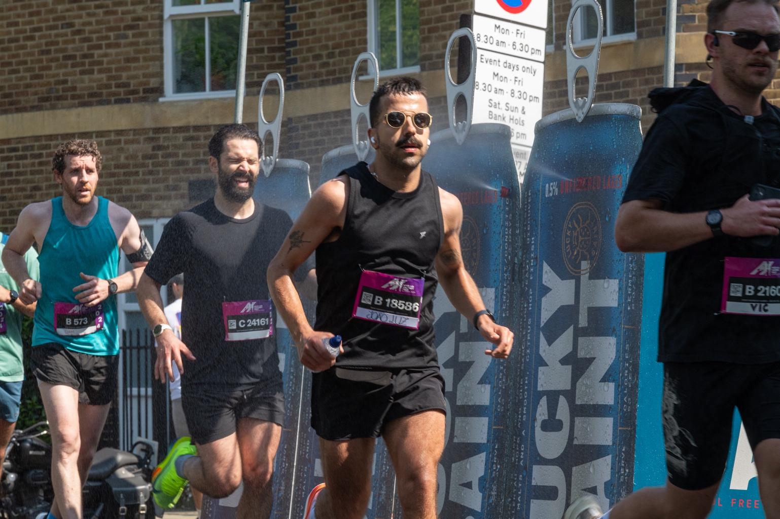 A group of men running in a race Description automatically generated