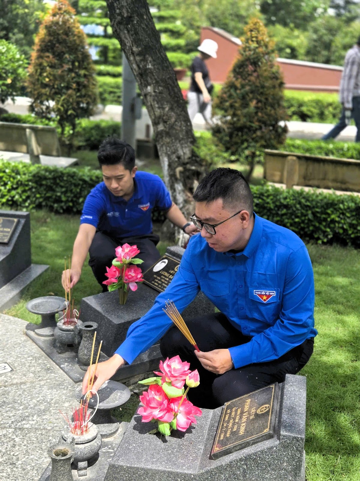 A group of men sitting on a graveAI-generated content may be incorrect.