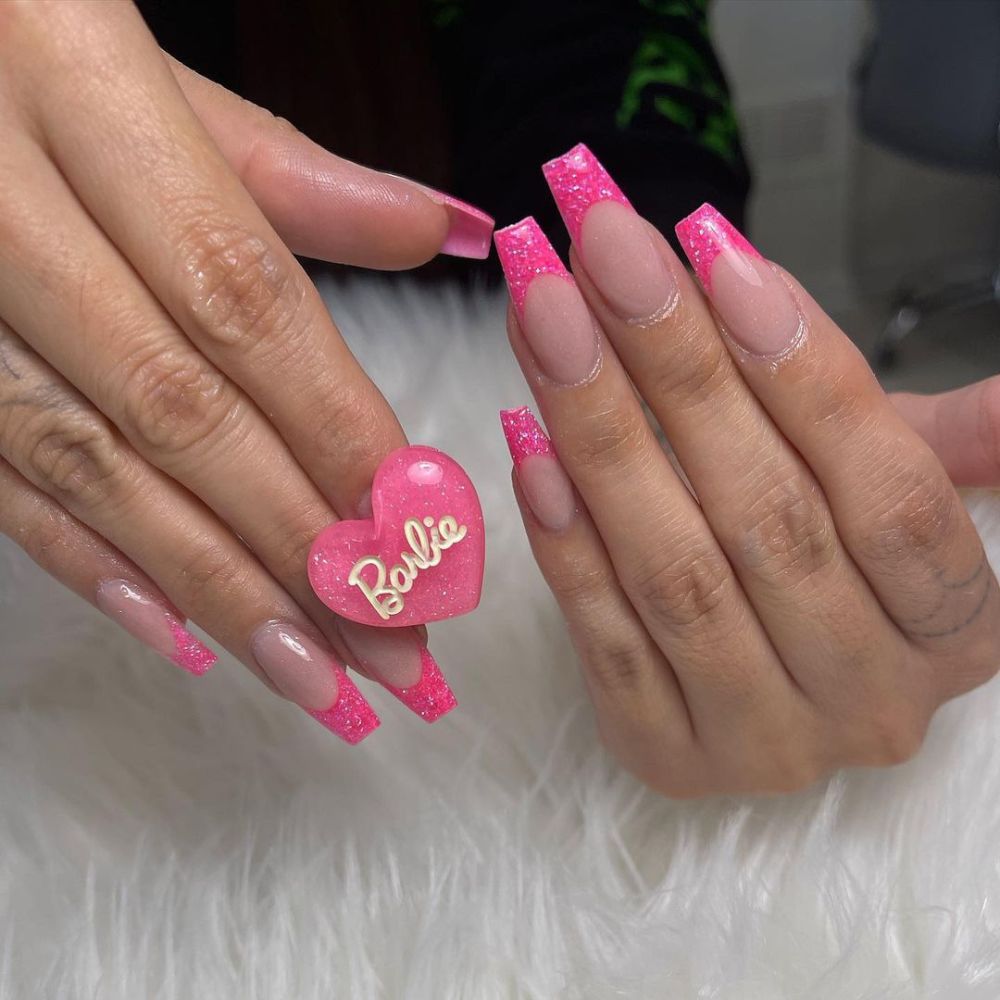 Close up of nails with simple pink nail designs having Barbie Pink Nails