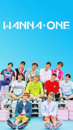 This contains an image of wanna one  group posing for a photo in front of blue background with pink crates