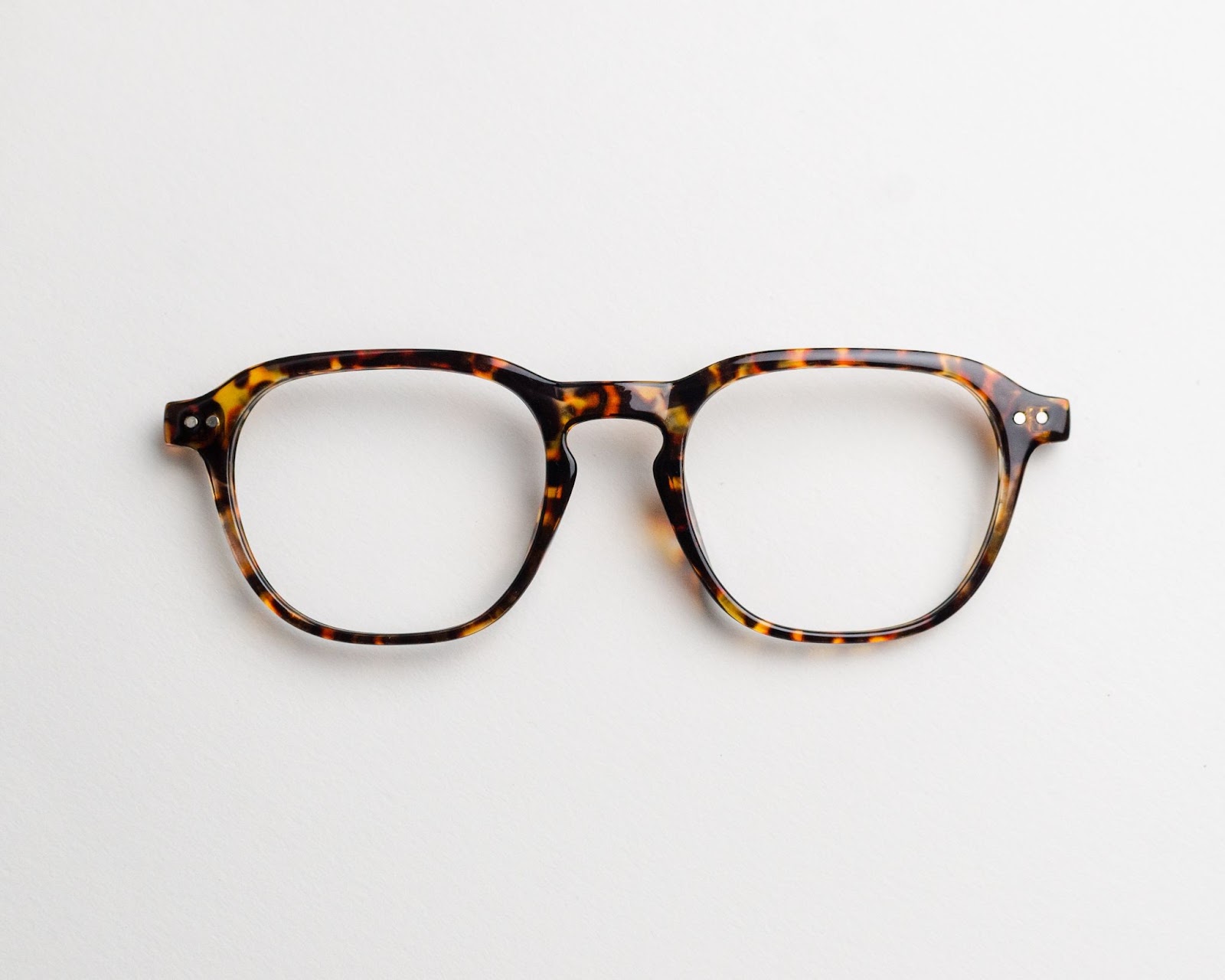 a pair of tortoise shell frame glasses on a white background.