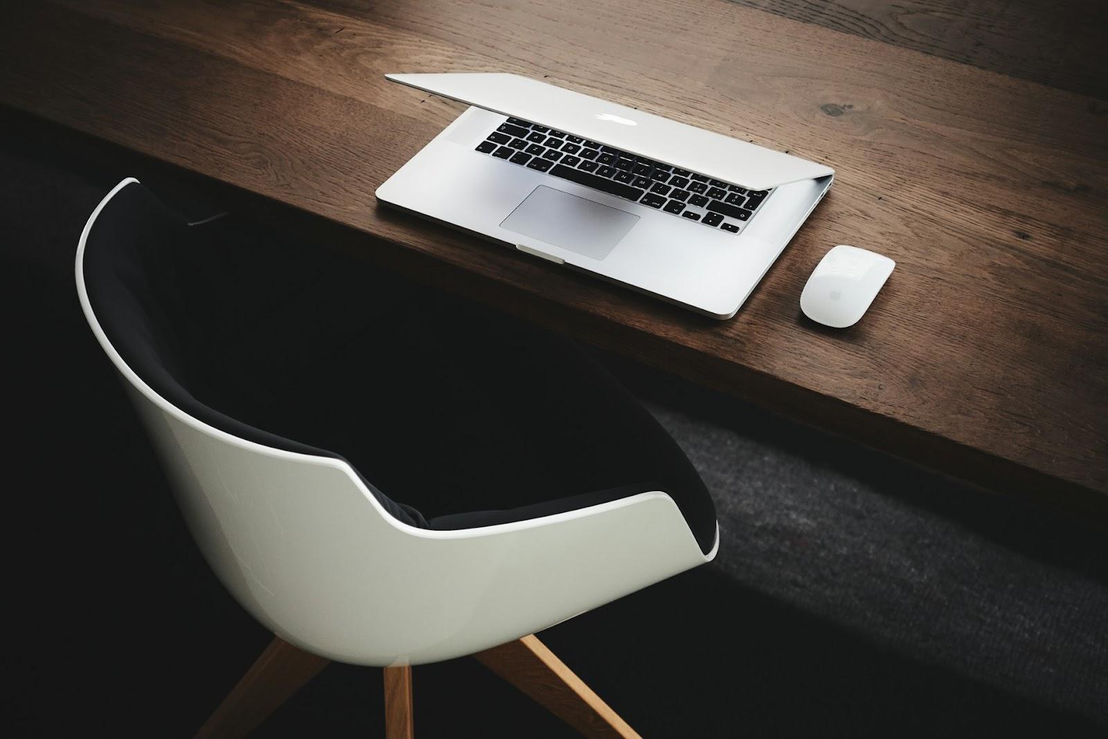 a chair, desk and Macbook