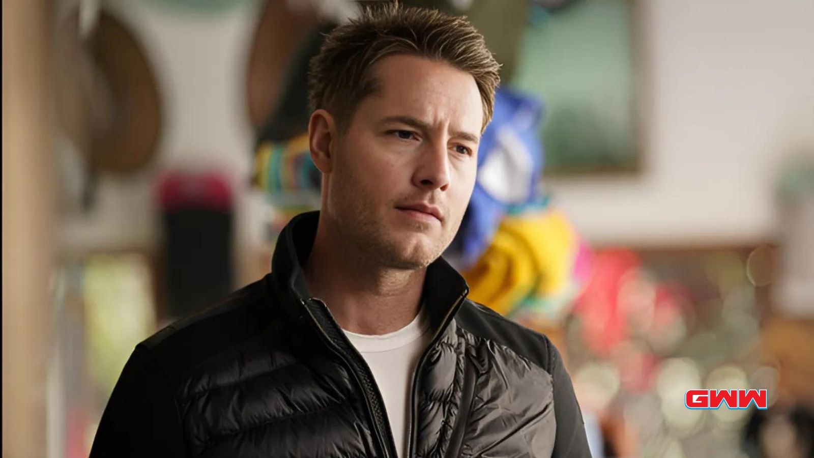 Justin Hartley in a shop, looking thoughtful, "Tracker" show