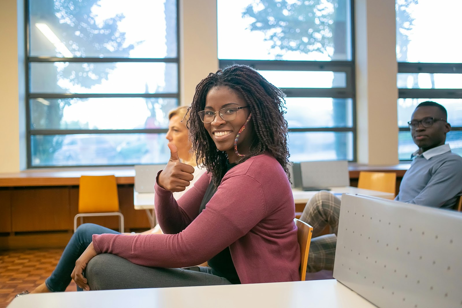 Student smiling in a classroom | Source: Pexels