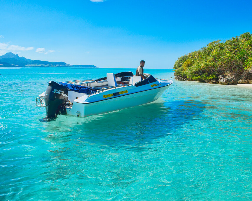 Boat floating on clear, calm water.