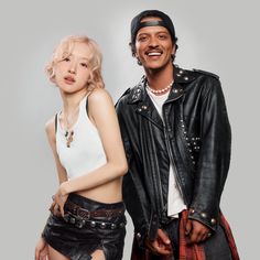 This contain an image of BLACKPINK's Rosé and Bruno Mars  posing together for a photo in black leather jackets, white tank top and red plaid skirt