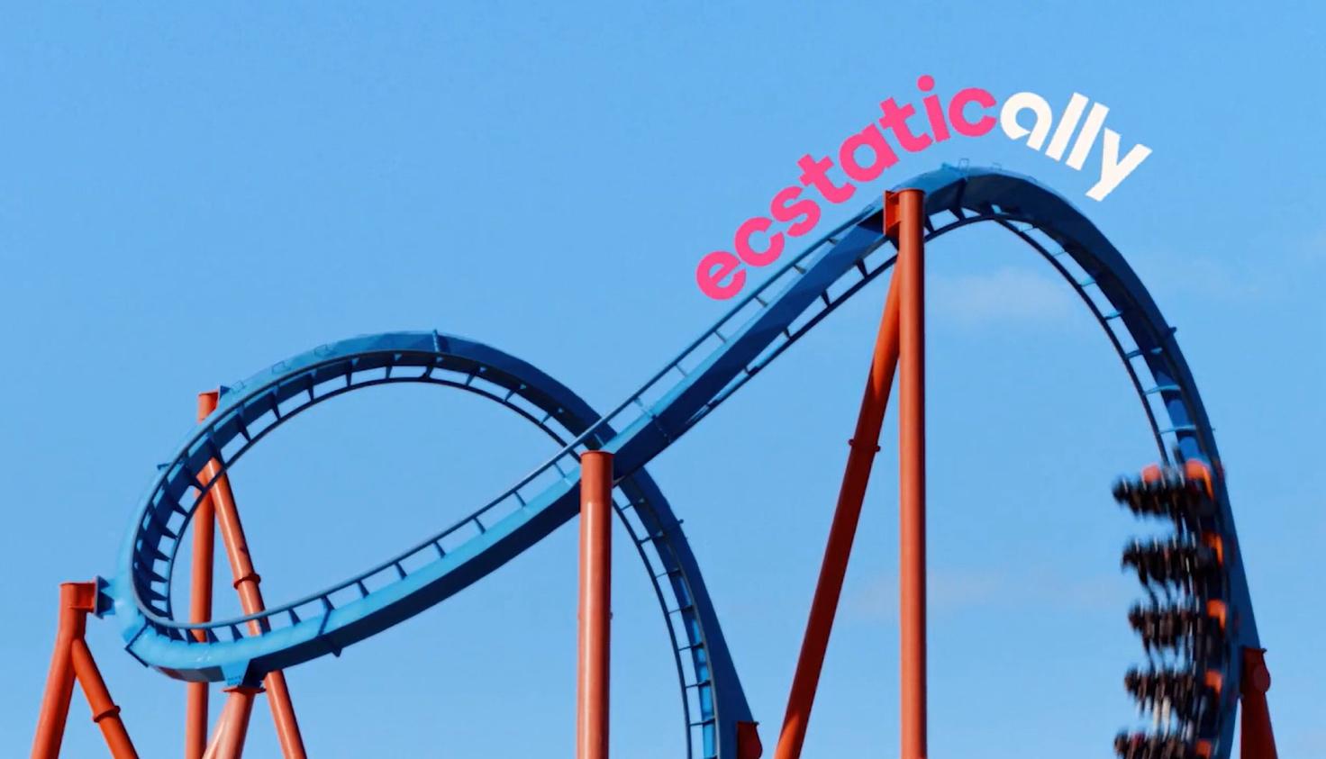 A roller coaster with a sign on top Description automatically generated