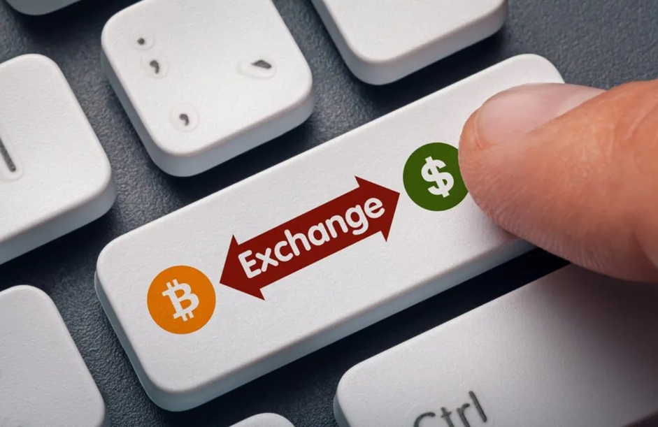  A man about to press a key labelled “Exchange” on a keyboard
