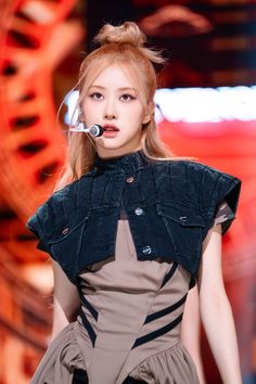 This contains an image of BLACKPINK's Rosé with a nosepiece in her mouth on the runway at a fashion show