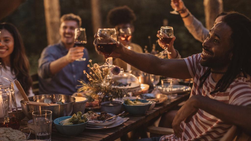 friends at a table cheering