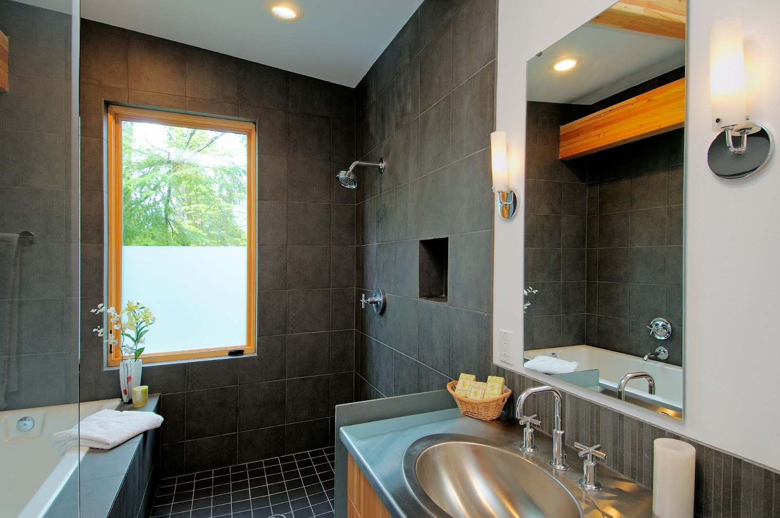 Gray-themed modern bathroom with sleek new shower and minimalist sink design.