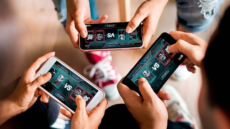 a group of hands holding phones