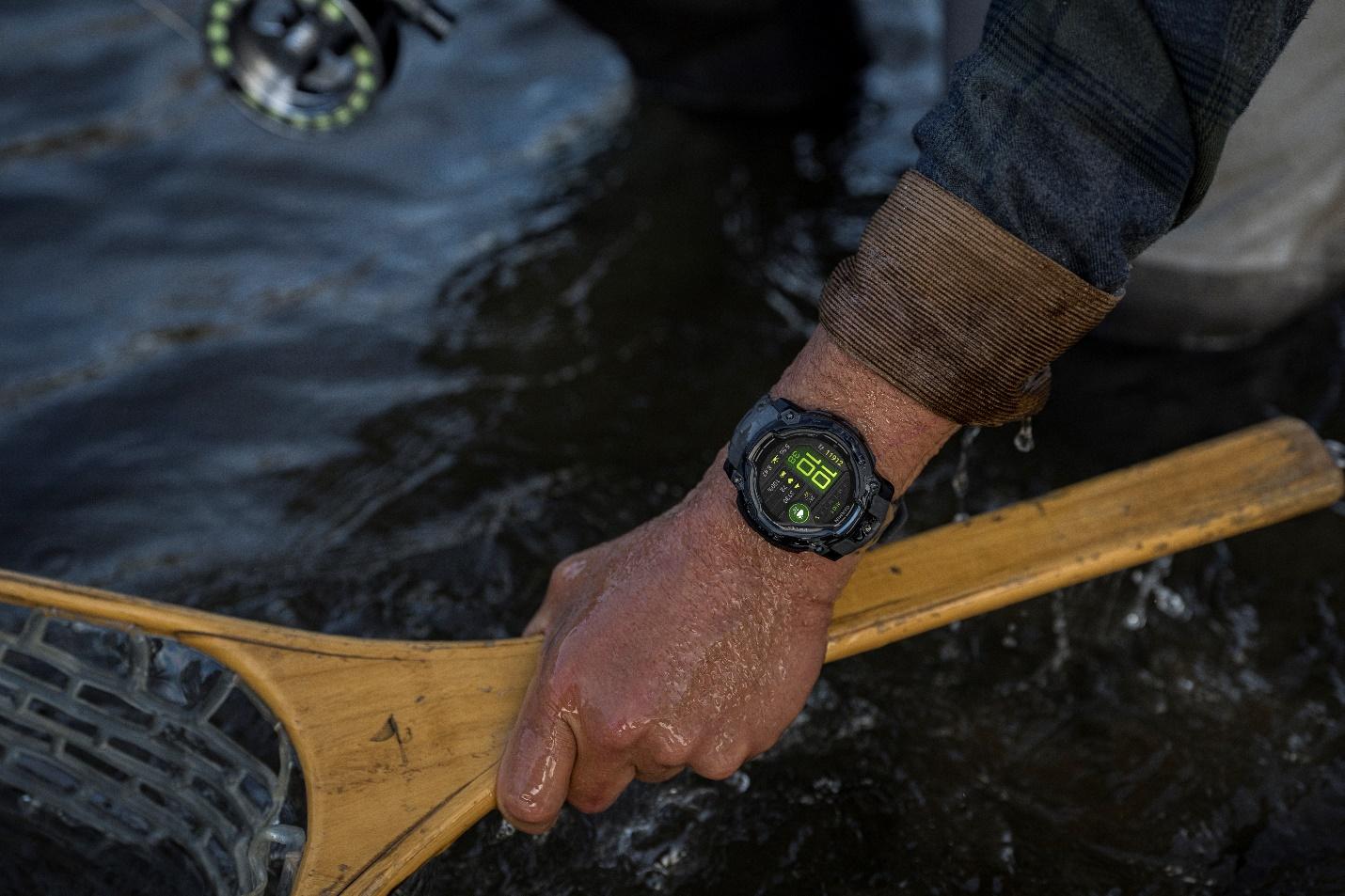 A person holding a stick in water

Description automatically generated