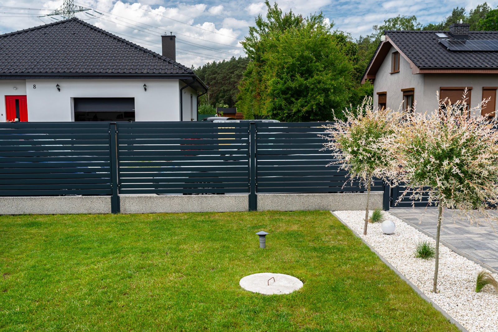 Modern steel fence surrounding a home. 