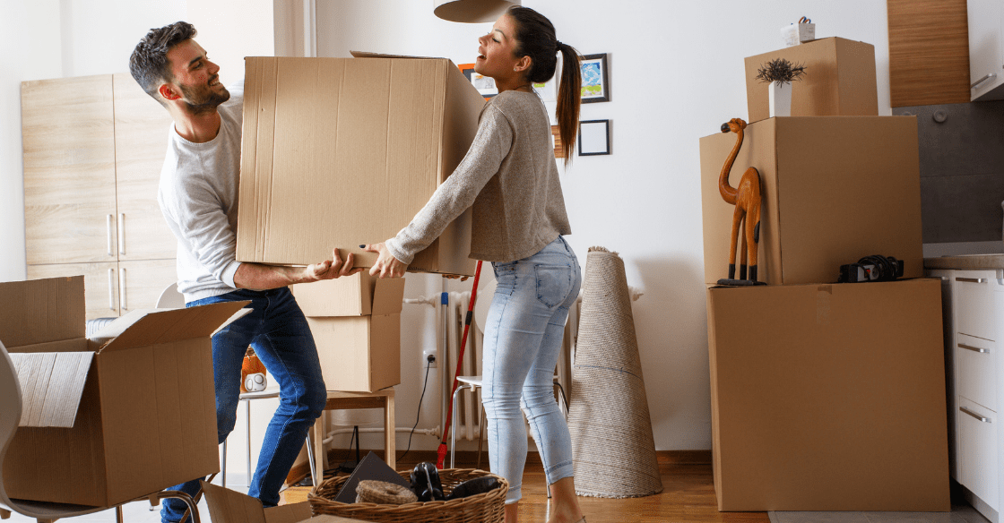 Young couple prepares their temperature and moisture-sensitive belongings for climate-controlled storage.