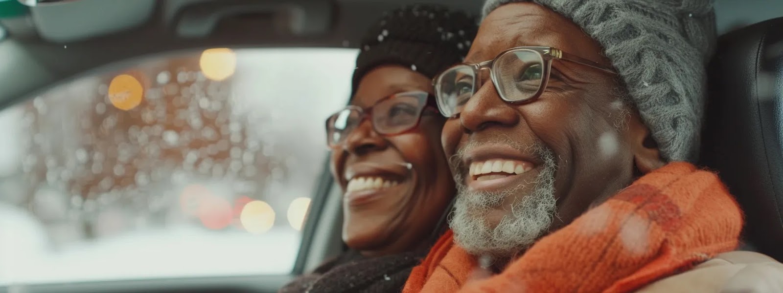 a senior couple smiling in front of their car, showcasing the benefits of age-related car insurance discounts in oklahoma city.