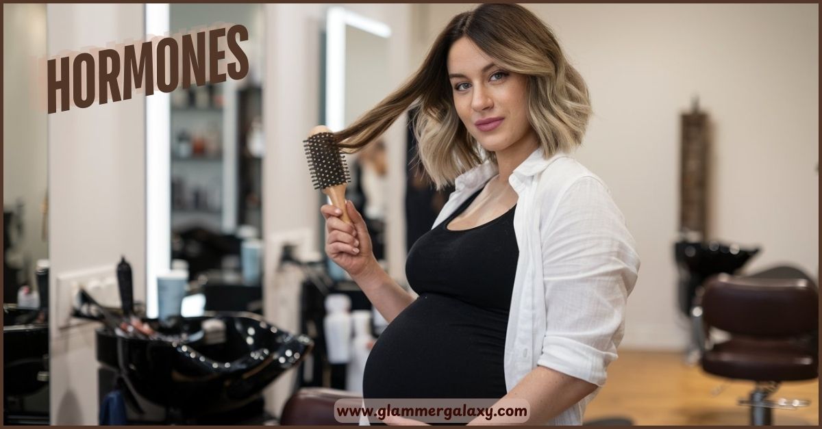 Pregnant individual holding brush in salon