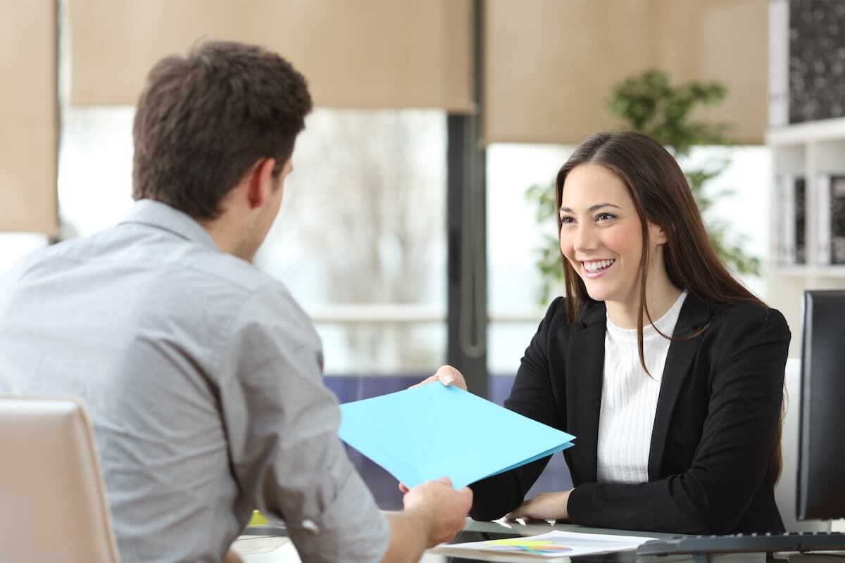 Leave of absence Florida: employee handing a folder to his manager