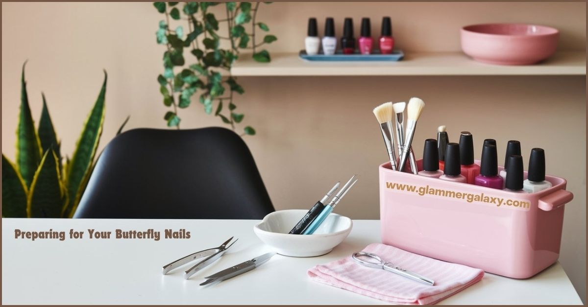 A pink manicure set with various tools and nail polish bottles on a table.