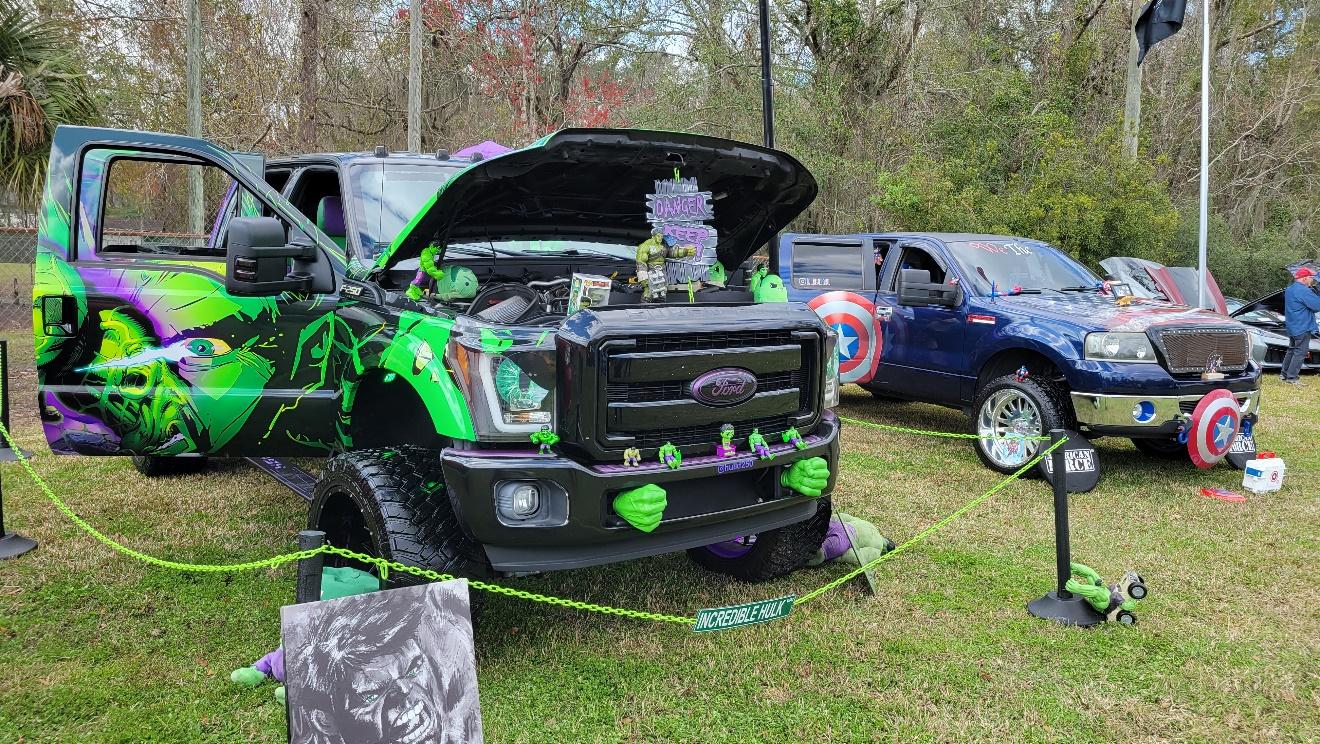 A black truck with green paint on it

AI-generated content may be incorrect.