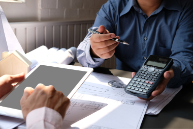 questions to ask home addition contractors in michigan remodeler reviewing budget with homeowner custom built okemos