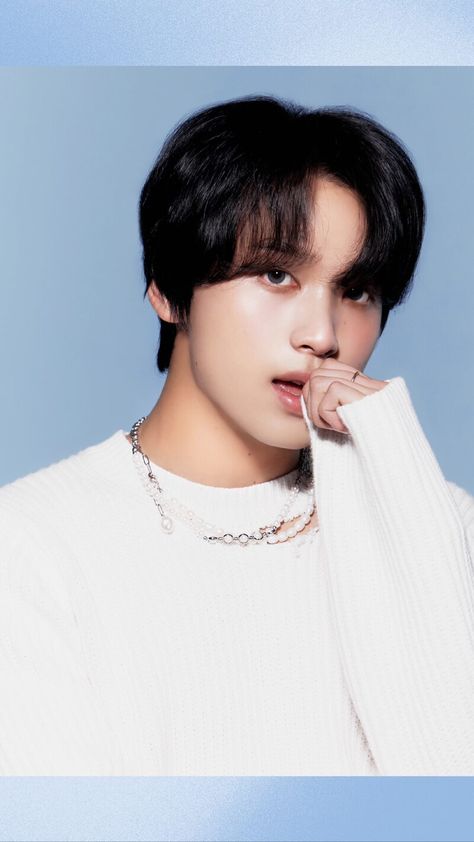 A picture of NCT Haechan on a white sweater with his hand in his mouth