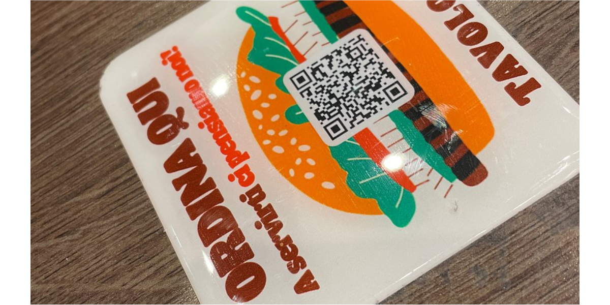 A Burger King QR Code sticker on a table.