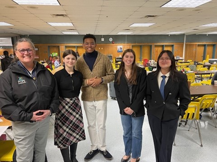 Dr. Reid with Falls Church High School student debaters at a debate tournament. 