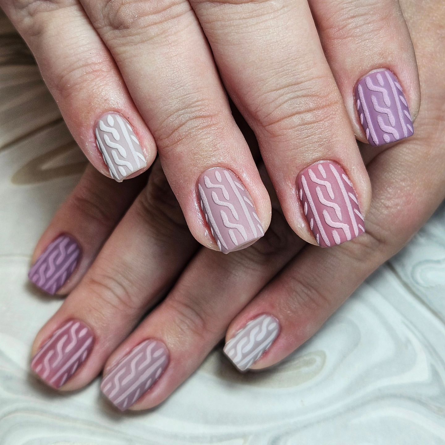 Close-up of hands with fall nail design having Cable Knit Patterns