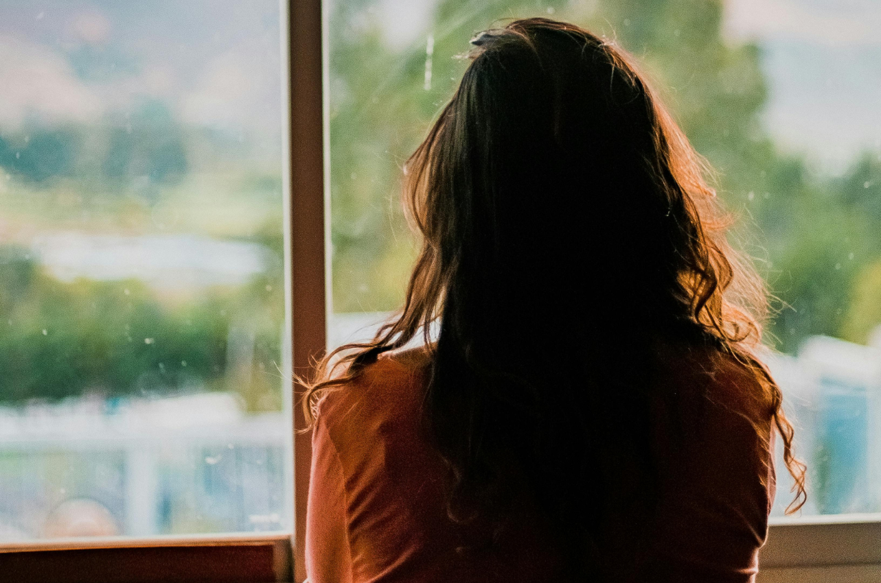 Woman staring out of a window // Healthier Baby Today