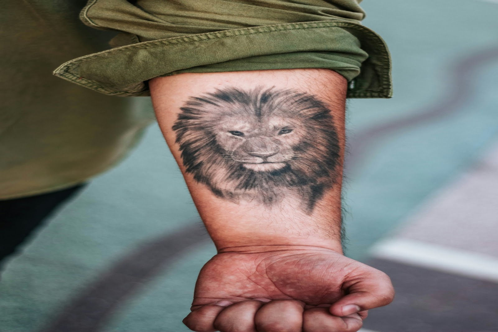 Zodiac tattoo ideas of lion on a forearm.