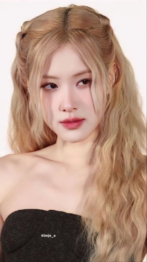 This contain an image of a blackpink Rose with long blonde hair wearing a strapless top and posing for the camera