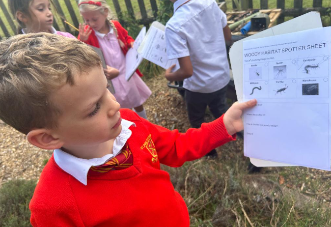 child showing their habitat worksheet