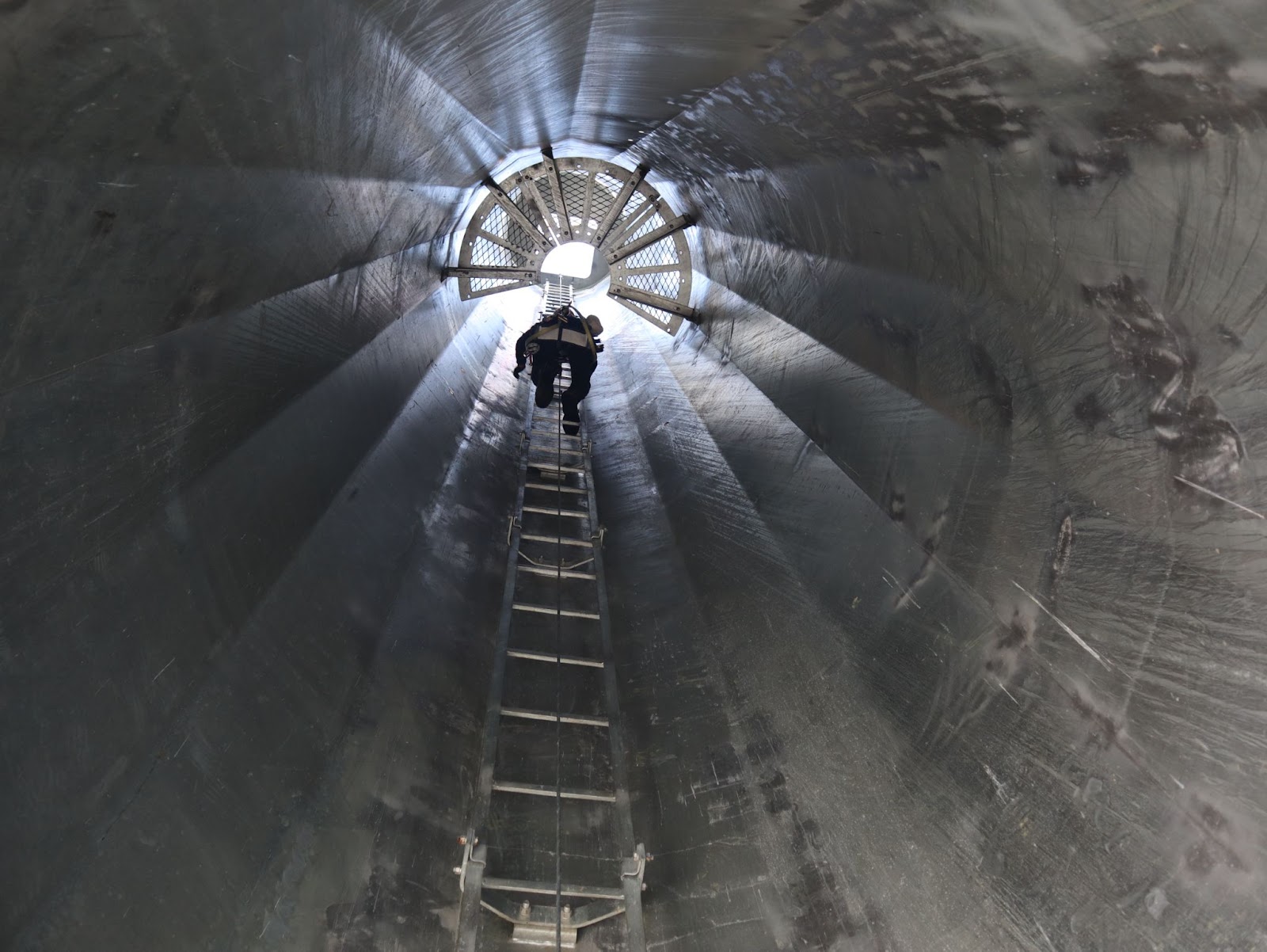 Pinnacle Career Institute student climbing up a mock wind turbine tower 