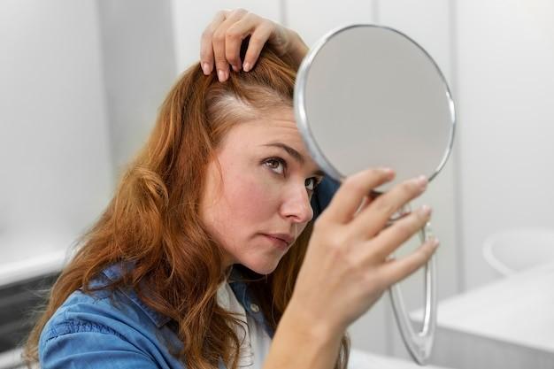 woman getting a hair loss treatment at a clinic, Picture