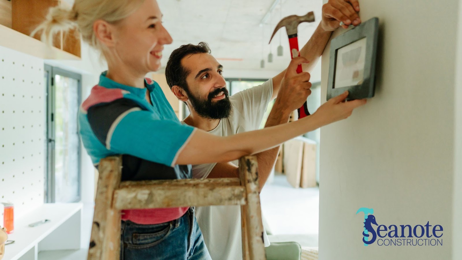 how to plan home renovation - should you DIY or hire a contractor -Two people working on a wall in a home