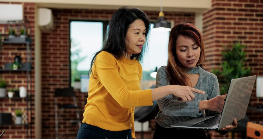 women discussing maintenance painting schedule for their businesses