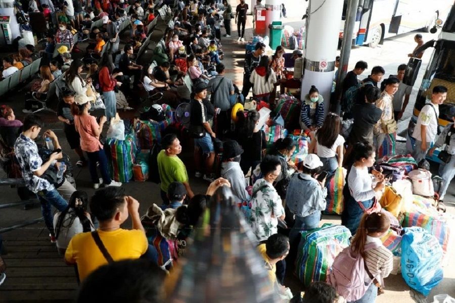 Tourists wait for buses to return home during the Songkran holiday in Bangkok