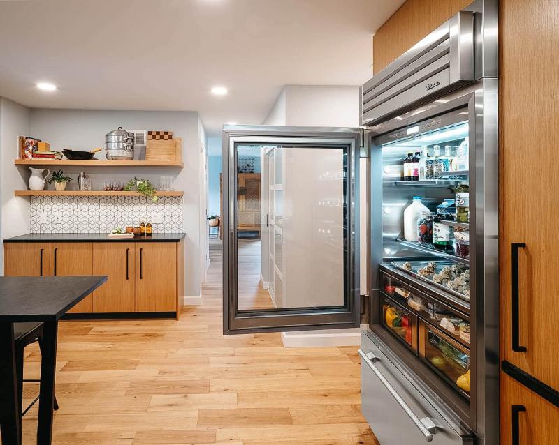 Sleek glass-door refrigerator displaying organised contents.