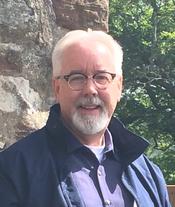 A person with white hair and beard wearing glasses AI-generated content may be incorrect.
