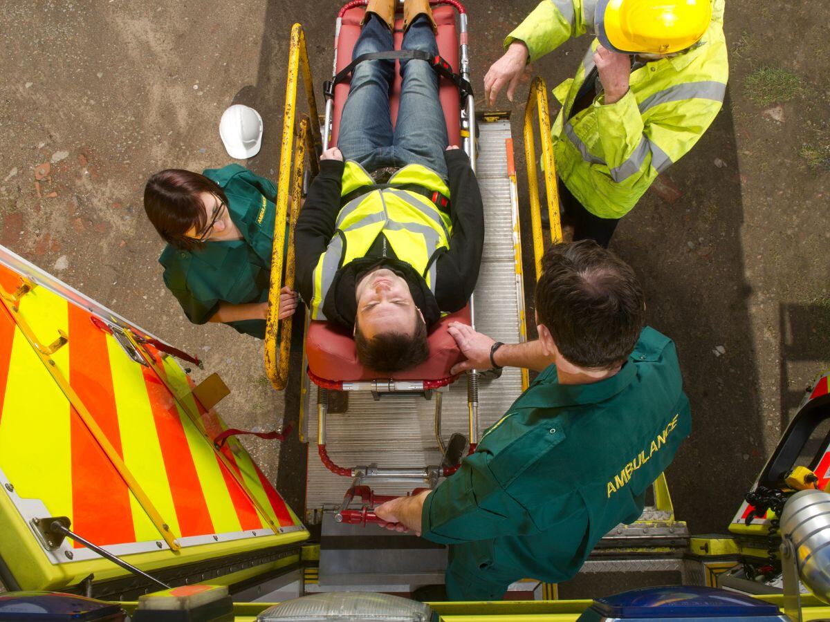 Injured Construction Worker being taken to a hospital in ambulance