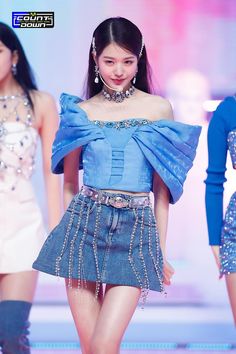 This contains an image of IVE Jang Wonyoung on sky blue top and jean