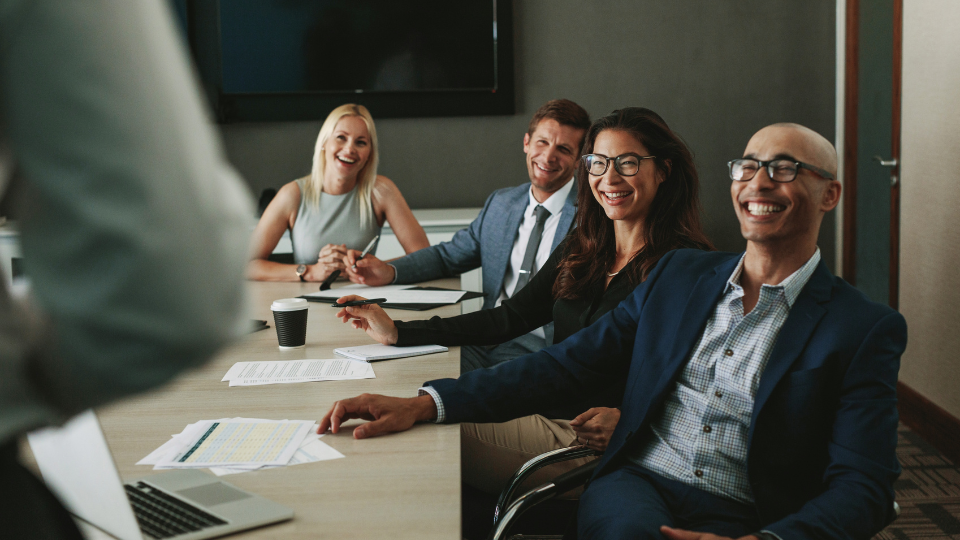 A group of business people sitting at a conference table