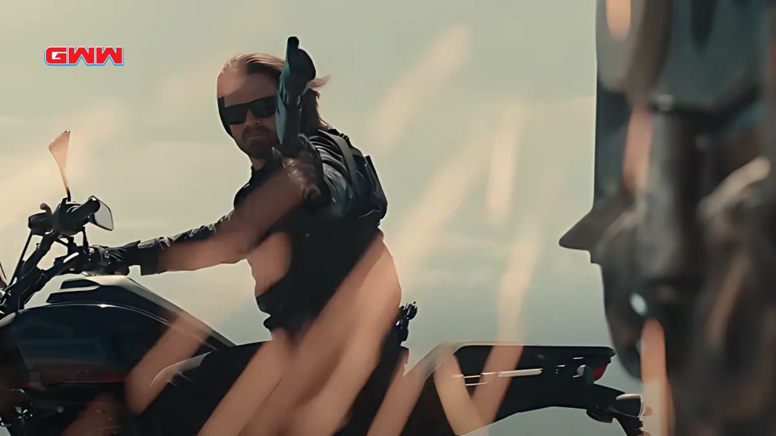 Sebastian Stan’s Bucky Barnes on a motorcycle with sunglasses and pointing a gun