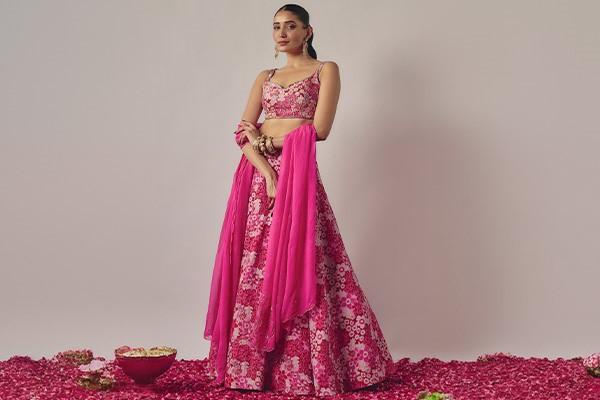 A person in a pink dress, lehenga