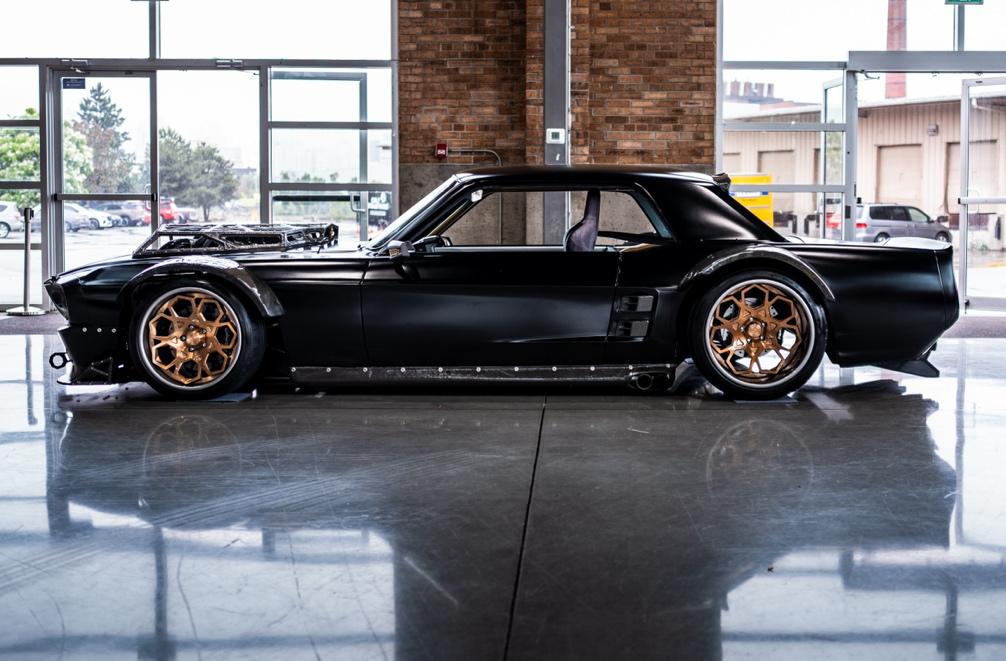 A black car parked in a building

AI-generated content may be incorrect.