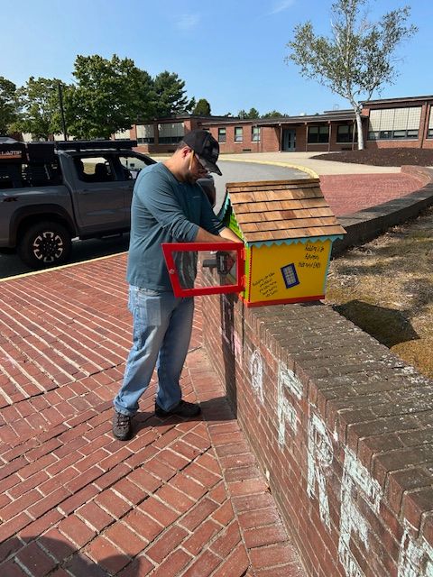 image of Mr. Ventura working on the outdoor free library