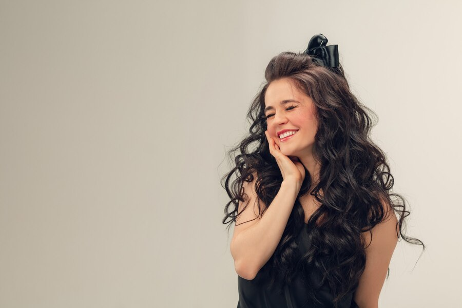 Portrait of beautiful young woman with curly hair