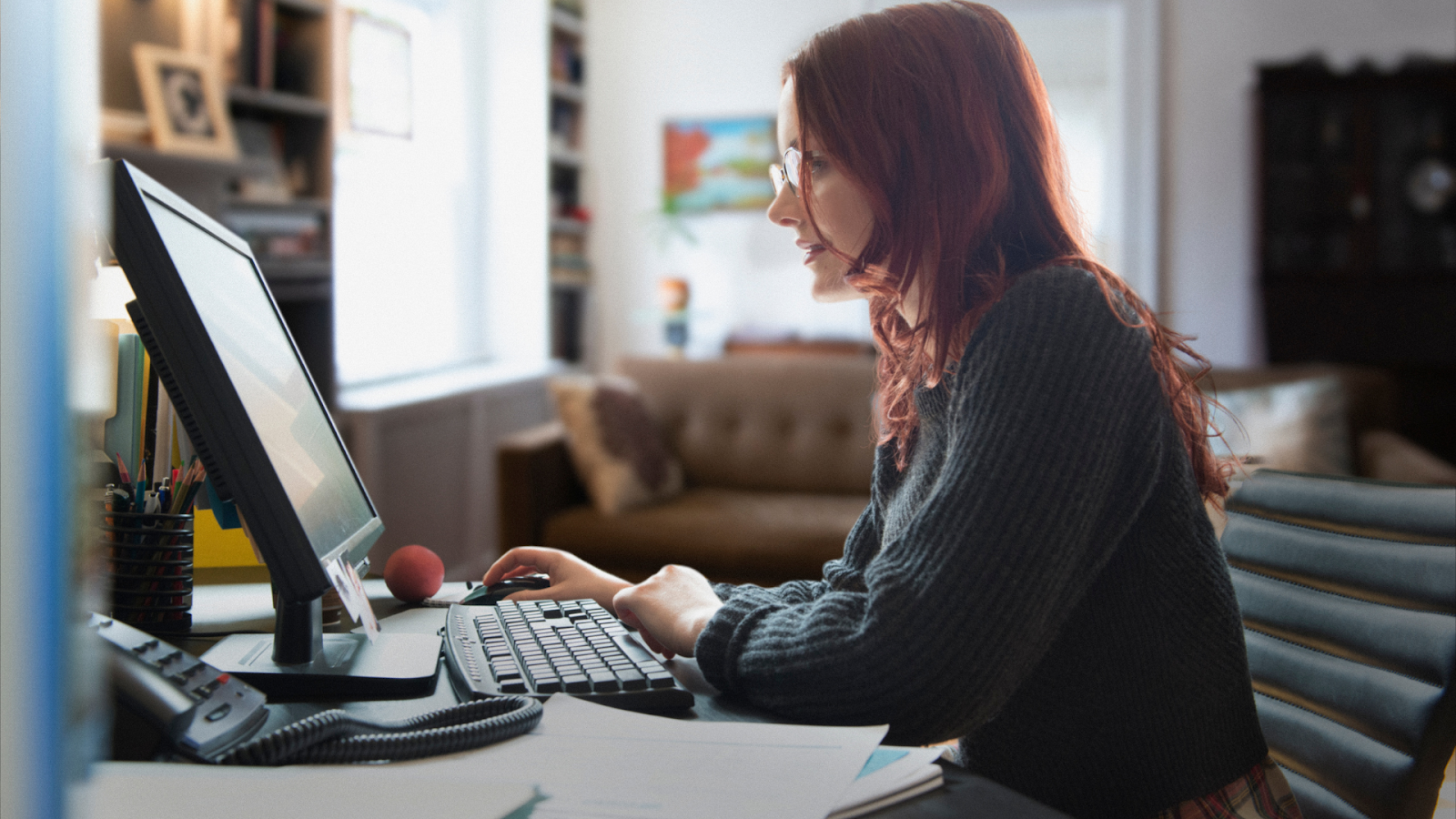 Woman having problems with her work computer while she is working from home