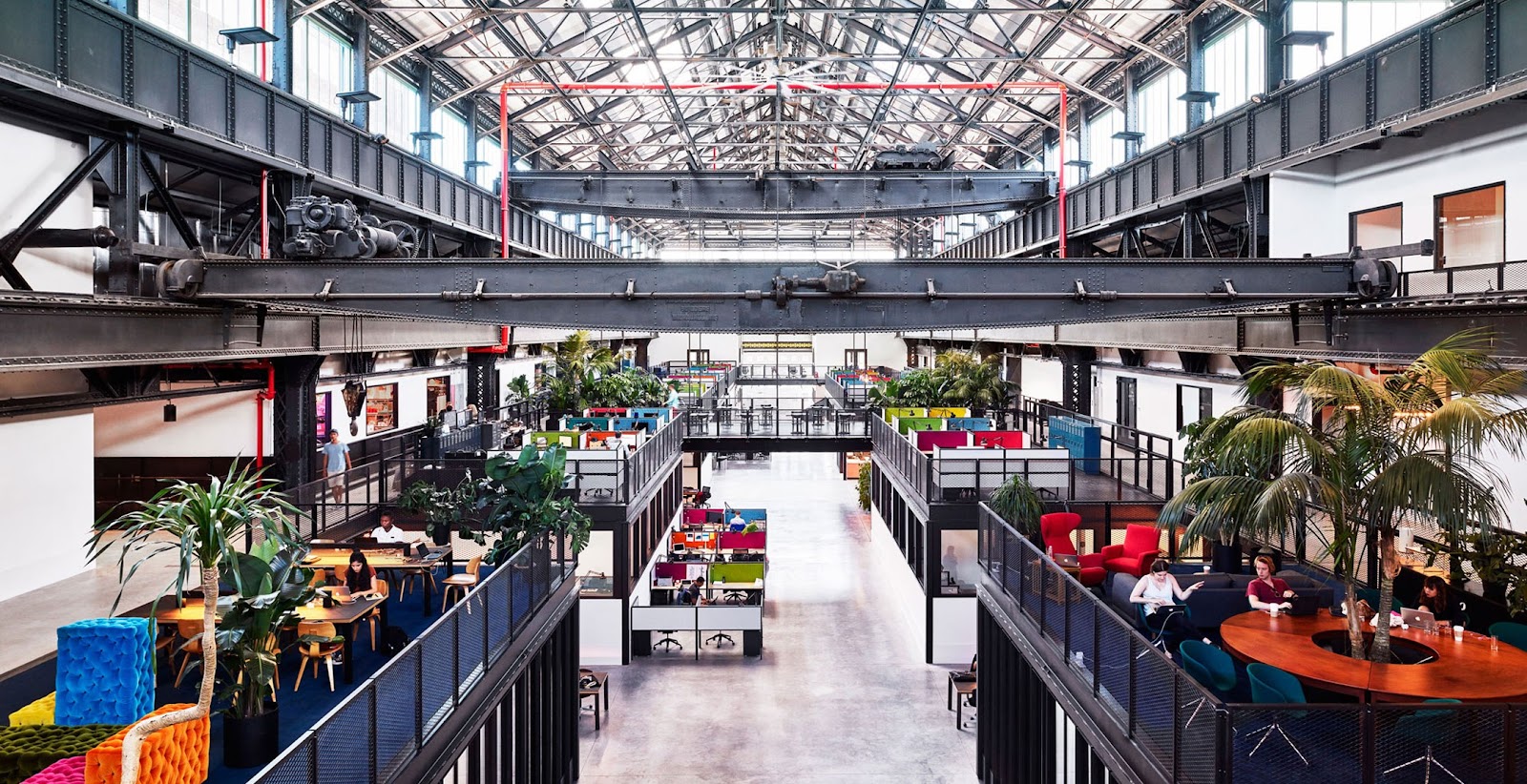 An industrial-style office space with high ceilings and metal beams showcases the revitalization of abandoned buildings.